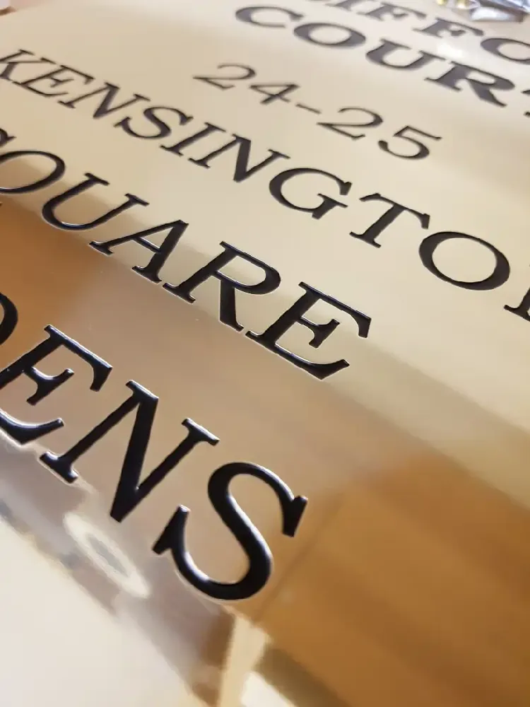 Engraved plaque and branded tags photographed on a clean background